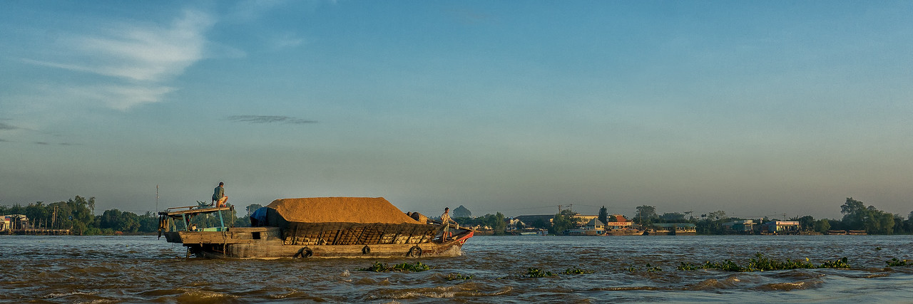 A boat in the morning sunshine on the Cổ Chiên River.