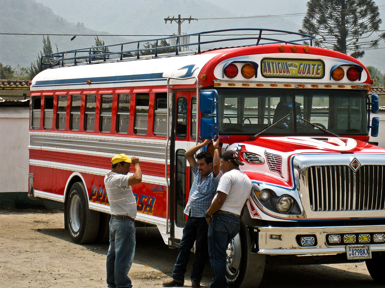 chicken bus drivers wait in the hot sun in antigua