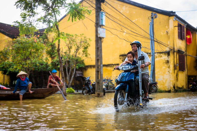 Dad on motorbike sustainable issues hoi an