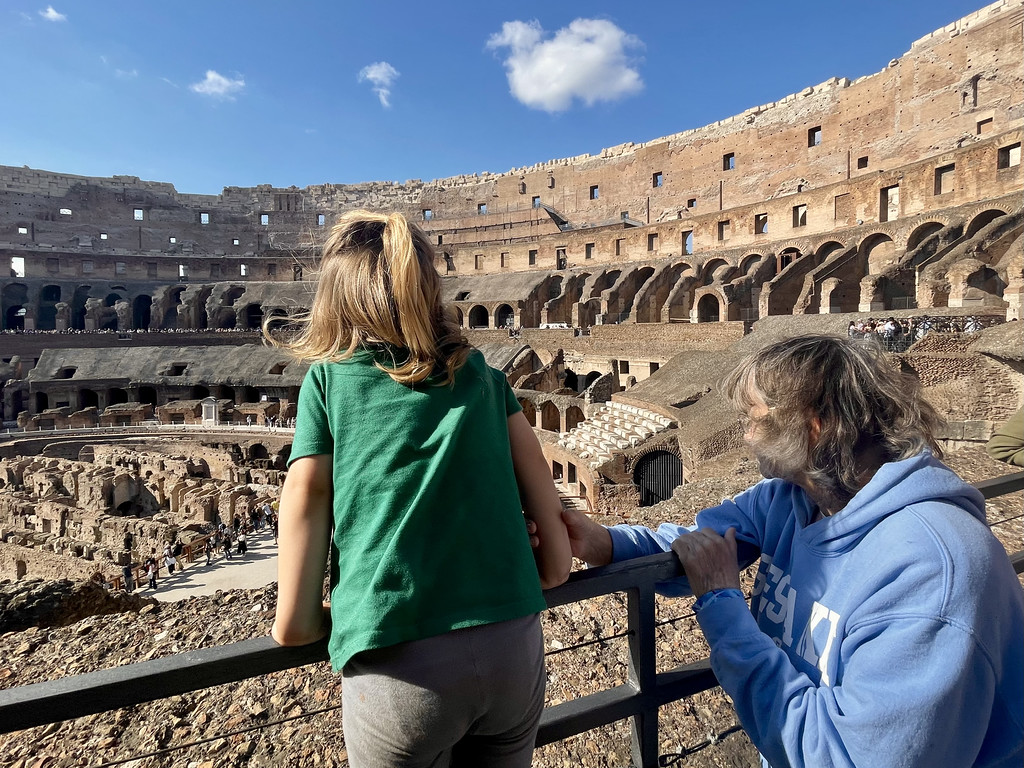 My toddler and mom looking out over the floor of the Colosseum.