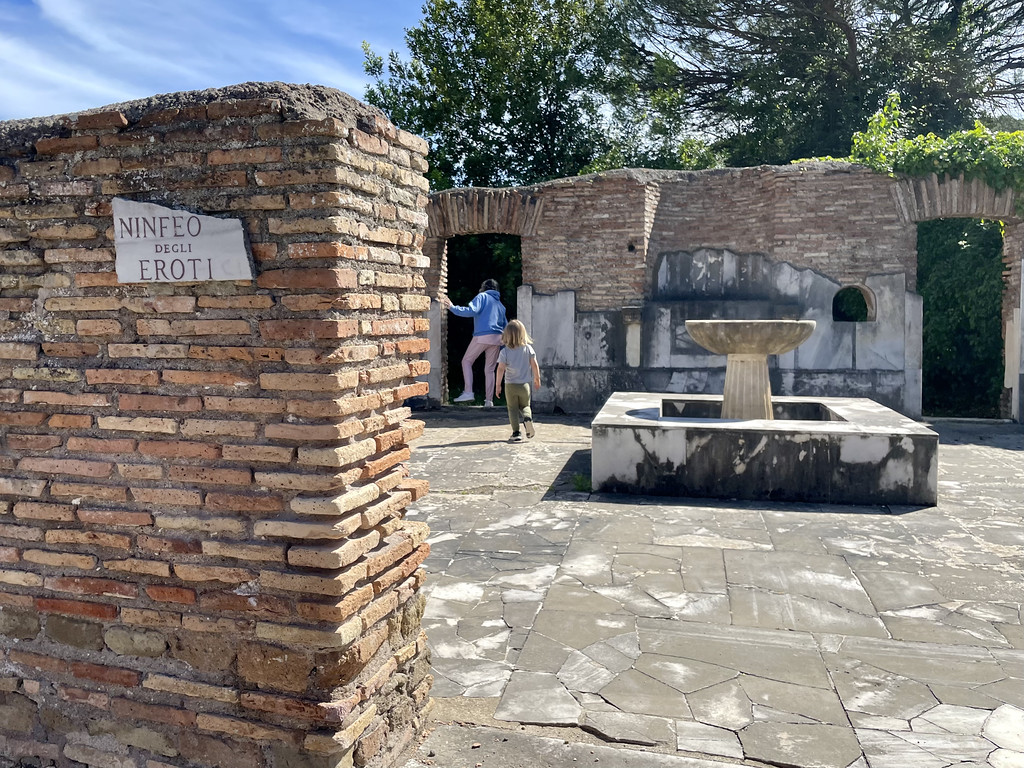 My toddler and mom explore the ruins in the baths of Neptune