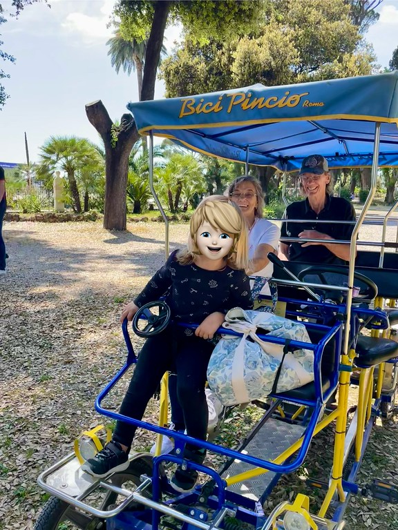 oddler riding pedal-assist bike in Villa Borghese Rome 