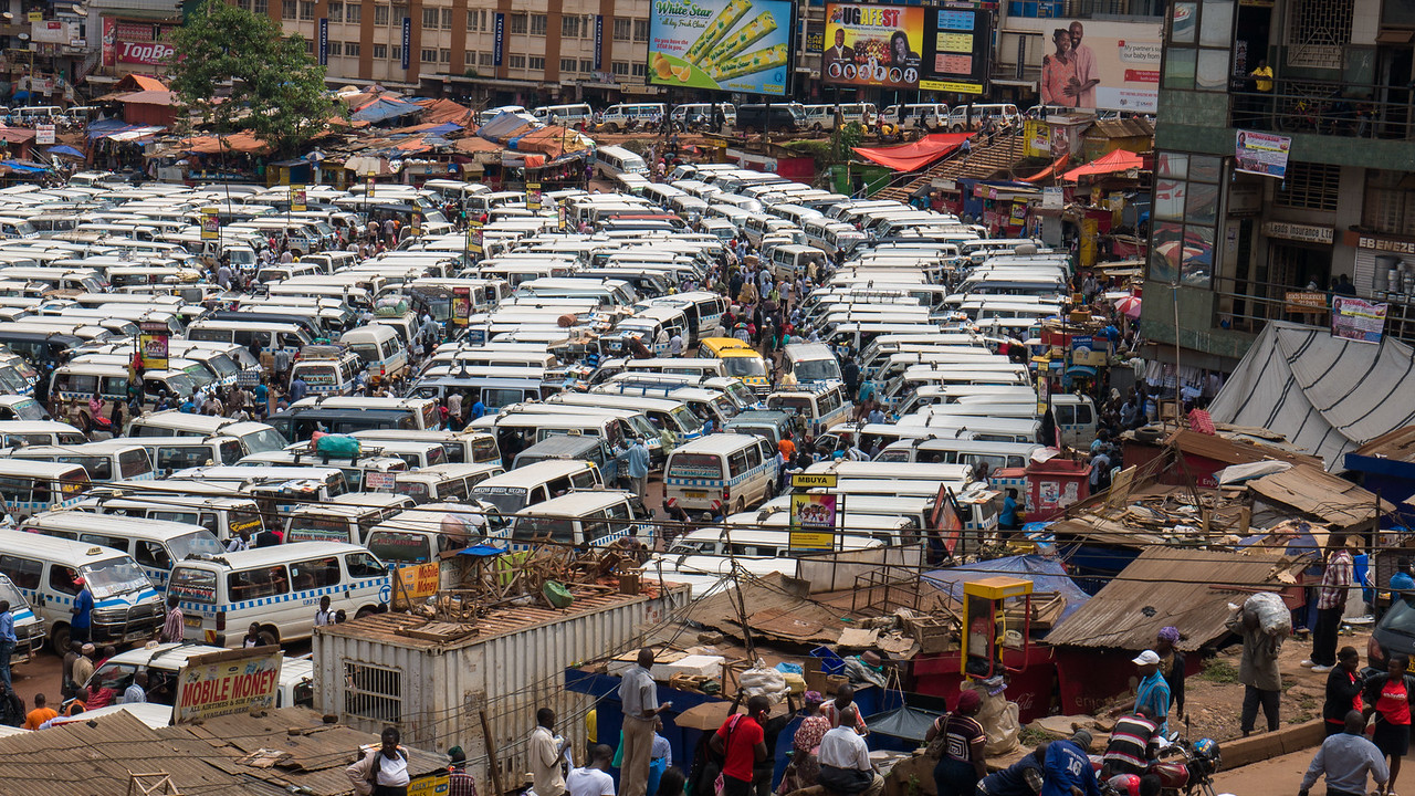 trasnportation in the developing world at a bus station filled with a parking lot of cars in kampala, uganda
