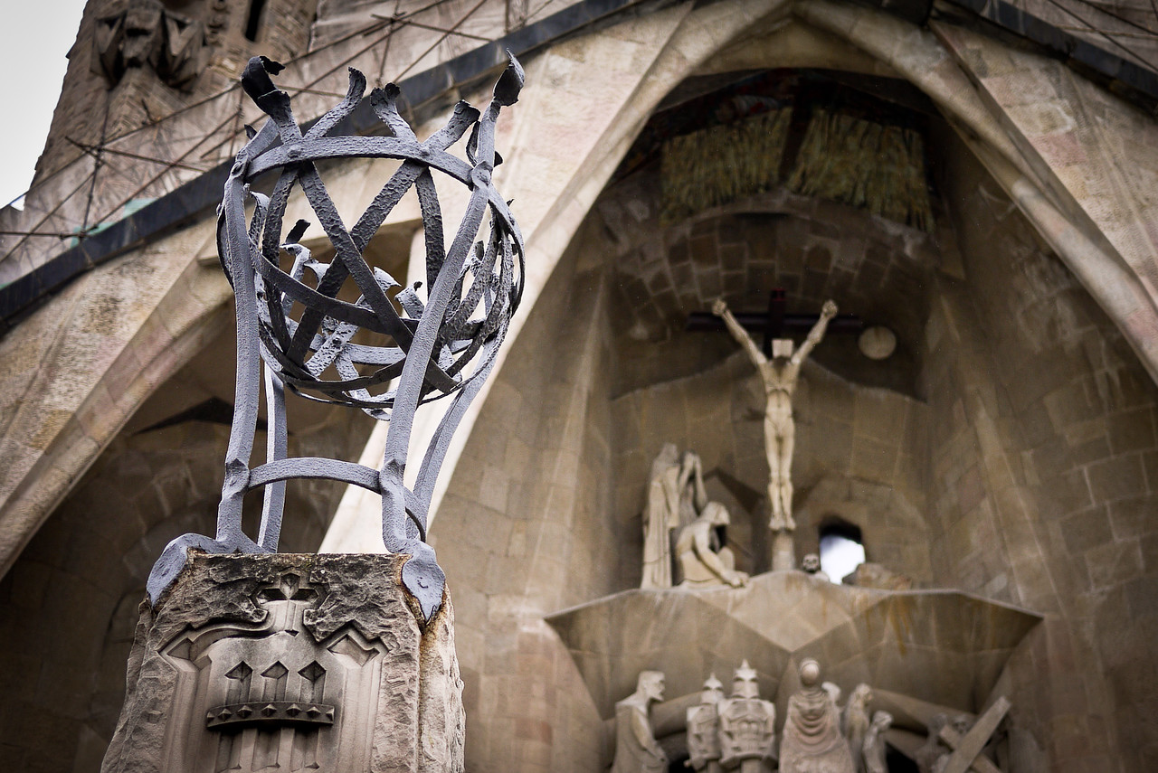 passion facade of the sagrada familiia with christ hanging in the background