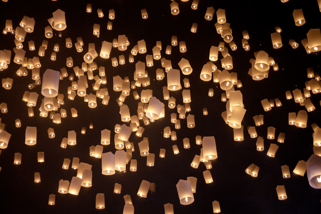 A wave of lanterns swiftly float into the air during Loy Krathong in Chiang Mai, Thailand