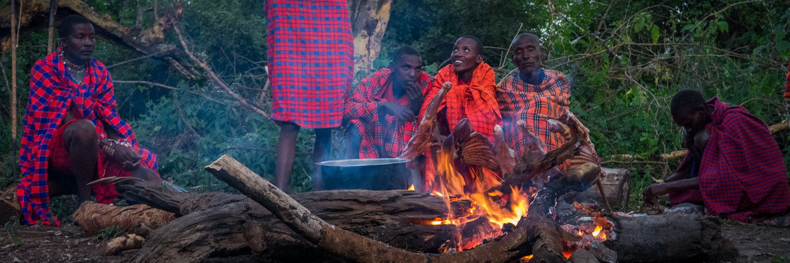 roasting goat over a campfire