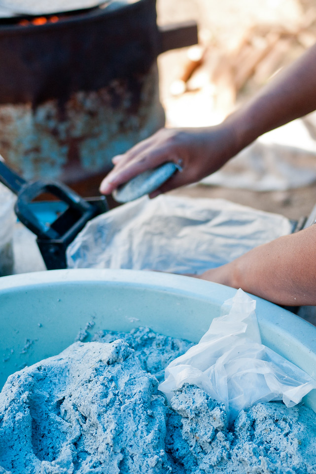 Learning how to make blue corn tortillas in from a street food vendor in Mexico.