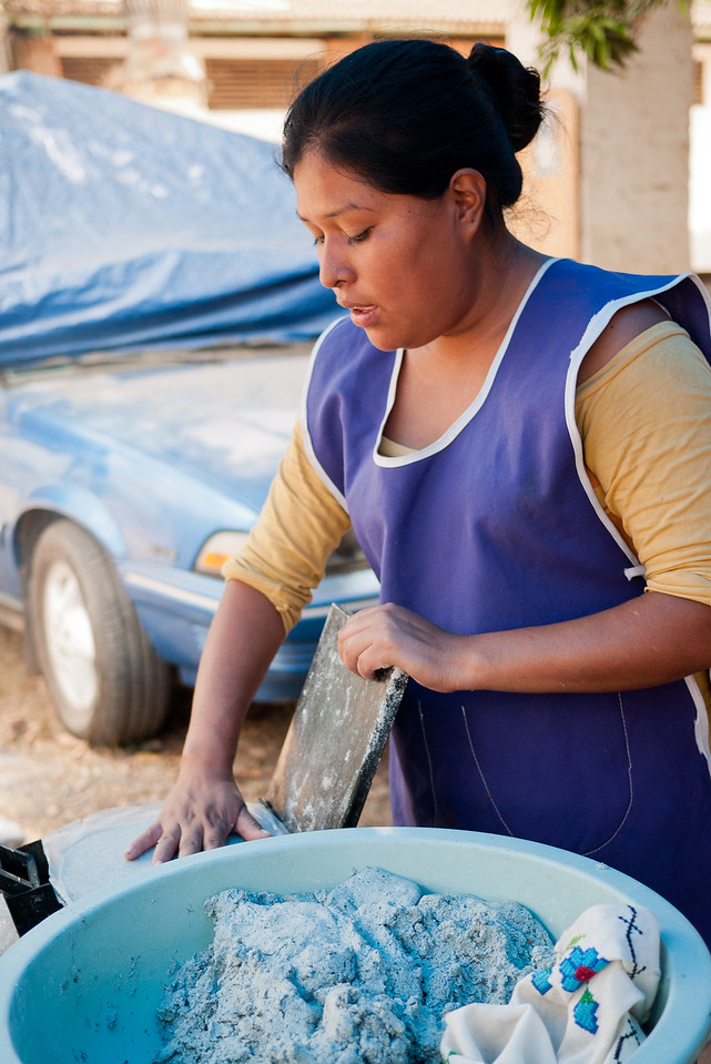 Learning how to make blue corn tortillas in from a street food vendor in Mexico.