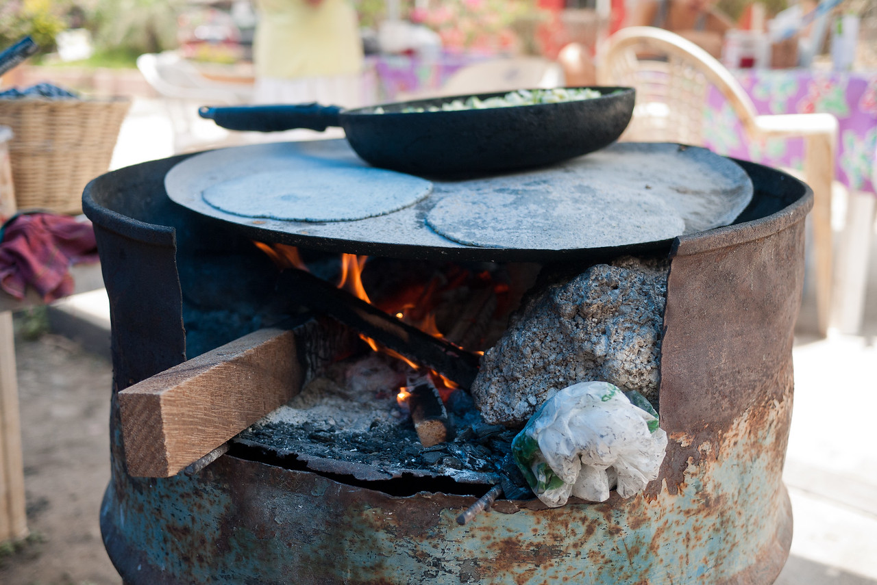 Veggies and blue corn tortillas on the stove. 
