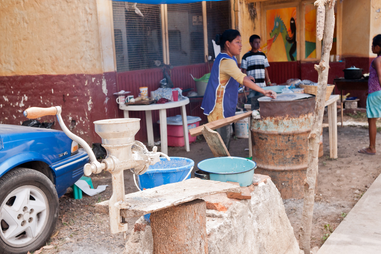 Learning how to make blue corn tortillas in from a street food vendor in Mexico.