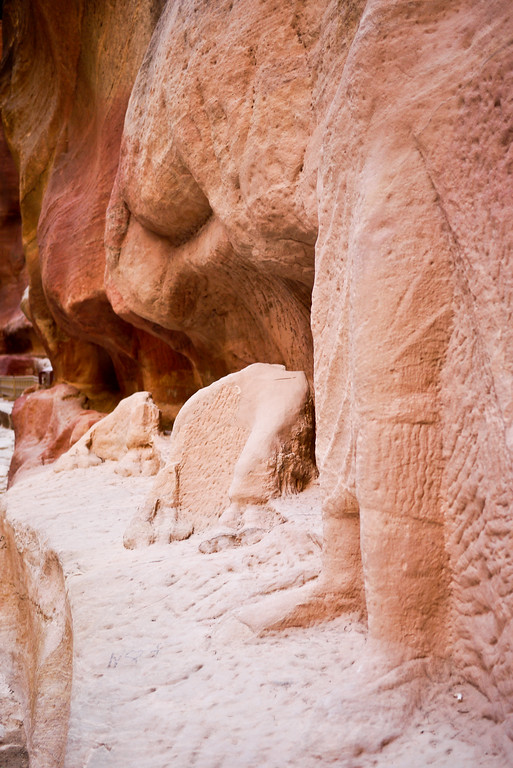 detailed carving remains of a Bedouin and his camel inside of Petra, Jordan.