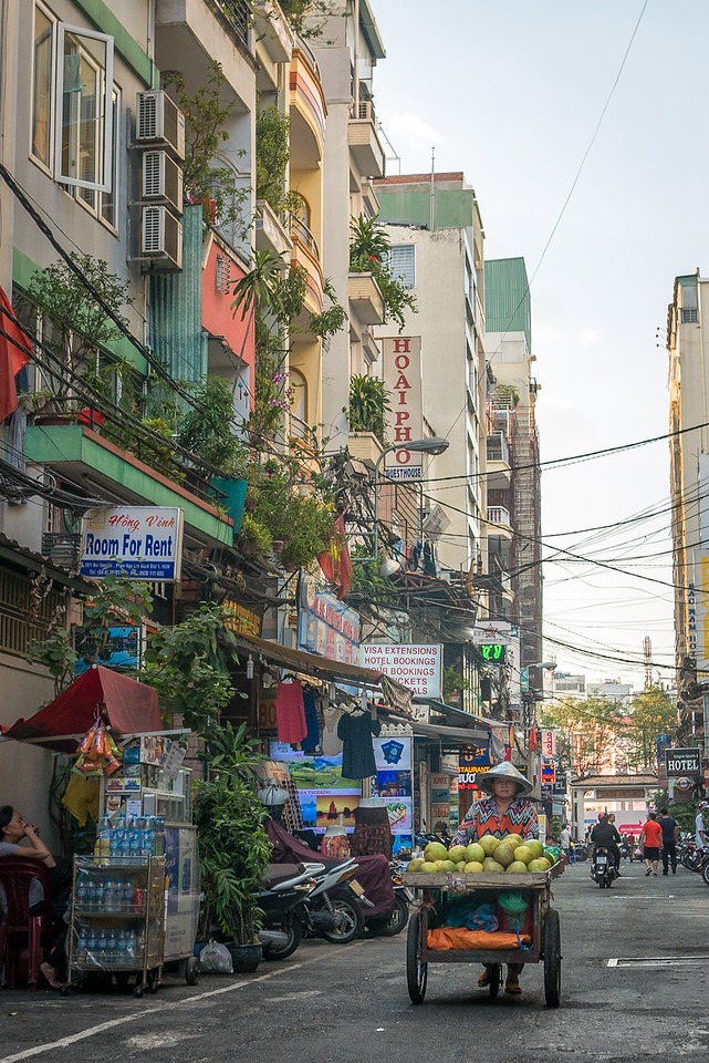 vendor walks the streets in saigon vietnam