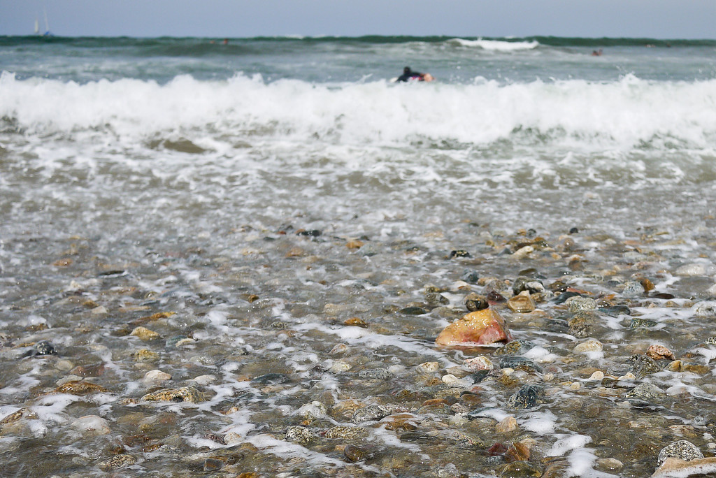 Surfers paddle out in the gentle waves around Sayulita beach.