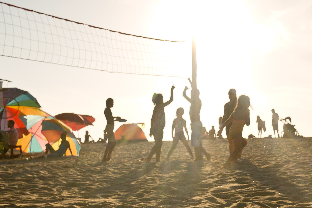 relaxing on a beach in mexico and playing volleyball