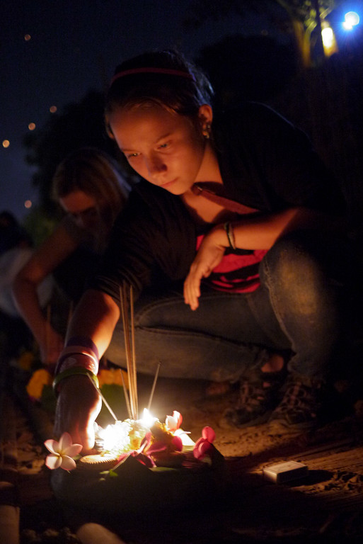 Ana lights her krathong for release during Loy Krathong in Chiang Mai, Thailand