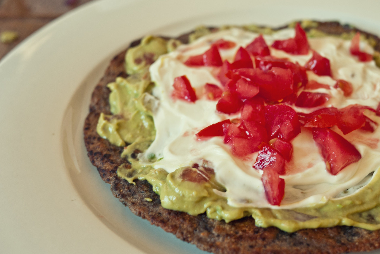 Fried tortilla with guacamole, sour cream and tomato