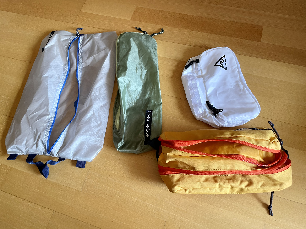 packing cubes of odd sizes and shapes, including long ones for socks, shoes, and toiletry kits