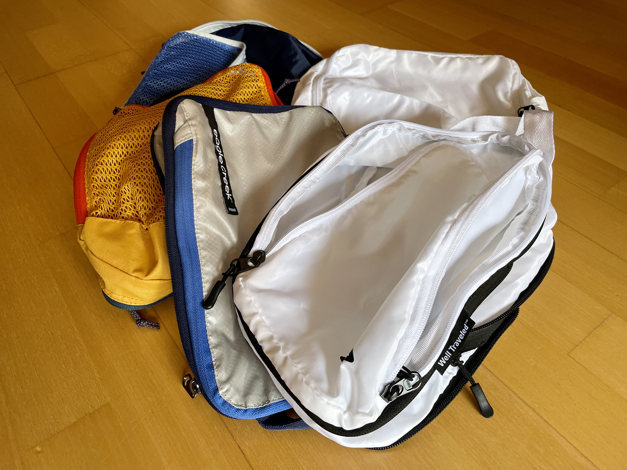 a small stack of expensive packing cubes, the price is a real con of them and why it's not worth it for some travelers